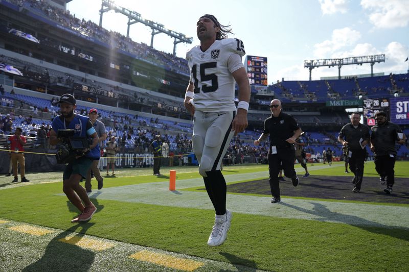 Las Vegas Raiders quarterback Gardner Minshew (15) celebrates after the Las Vegas Raiders defeated the Baltimore Ravens in an NFL football game, Sunday, Sept. 15, 2024, in Baltimore. (AP Photo/Stephanie Scarbrough)