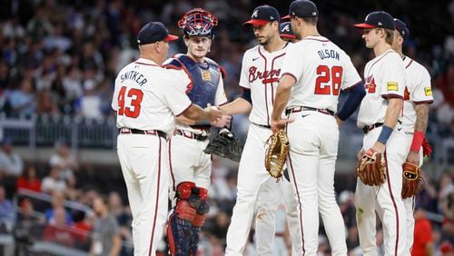 Braves pitcher Charlie Morton (50)  is removed from the game by manager Brian Snitker (43) during the seventh inning of Monday's game against the Reds at Truist Park. (Miguel Martinez/ AJC)