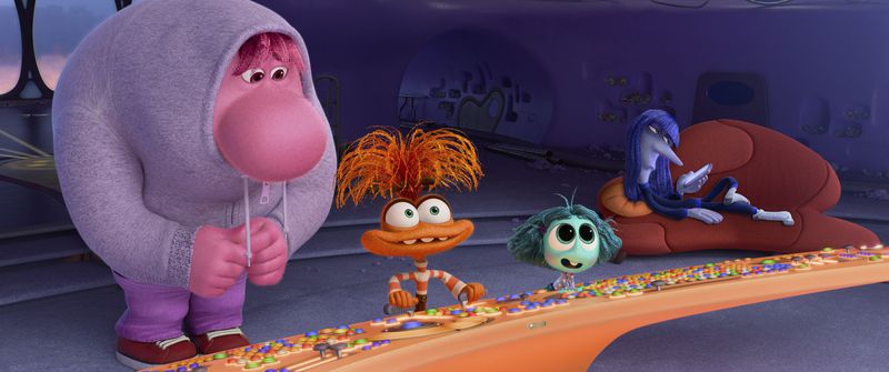 This image released by Disney/Pixar shows, from left, Embarrassment, voiced by Paul Walter Hauser, Anxiety, voiced by Maya Hawke, Envy, voiced by Ayo Edebiri, and Ennui, voiced by Adèle Exarchopoulos in a scene from "Inside Out 2." (Disney/Pixar via AP)