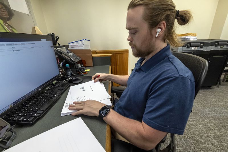 Trey Forrest, Absentee Election Coordinator for the Jefferson County/Birmingham (Ala) Division, prepares absentee ballots for the November election, Tuesday, Sept. 10, 2024, in Birmingham, Ala. (AP Photo/Vasha Hunt)