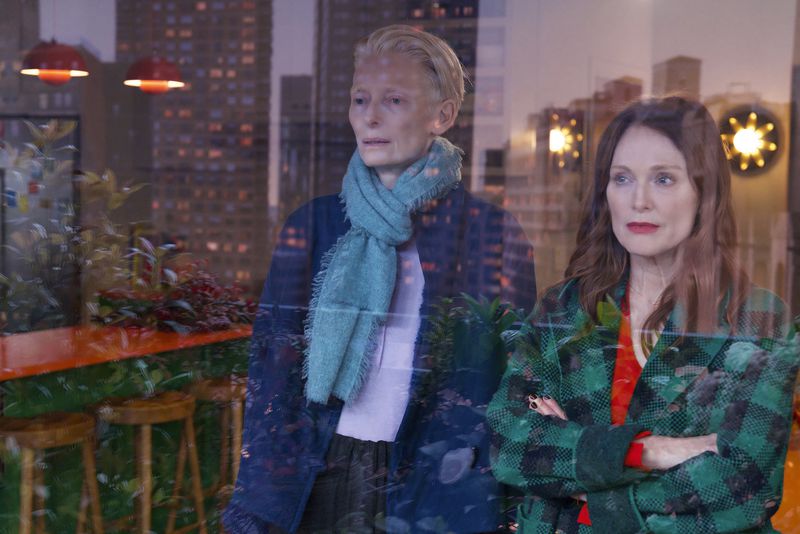 This image released by Sony Pictures Classics shows Julianne Moore, right, and Tilda Swinton in a scene from "The Room Next Door." (Sony Pictures Classics via AP)