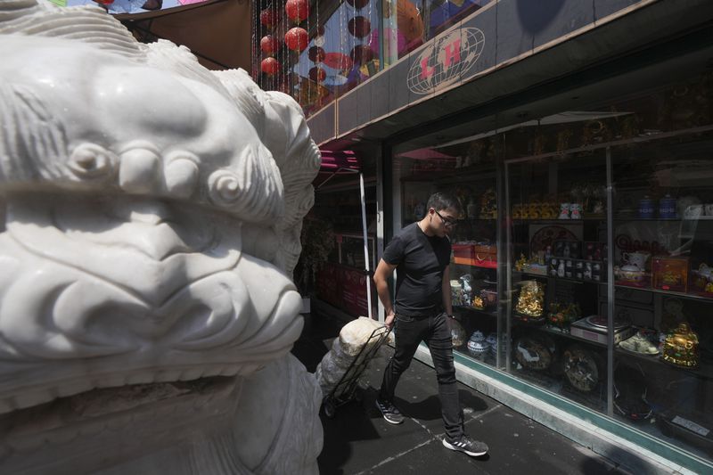 A man pulls bags of bean sprouts in Chinatown, in Mexico City's historic center, Saturday, June 8, 2024. (AP Photo/Fernando Llano)