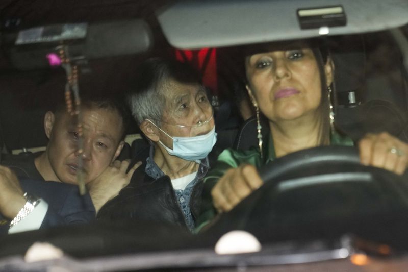 FILE - Peru's former President Alberto Fujimori, center, is driven out of prison by one of his lawyers, accompanied by his son Kenji, left, after his release, in Callao, Peru, Dec. 6, 2023. (AP Photo/Martin Mejia, File)