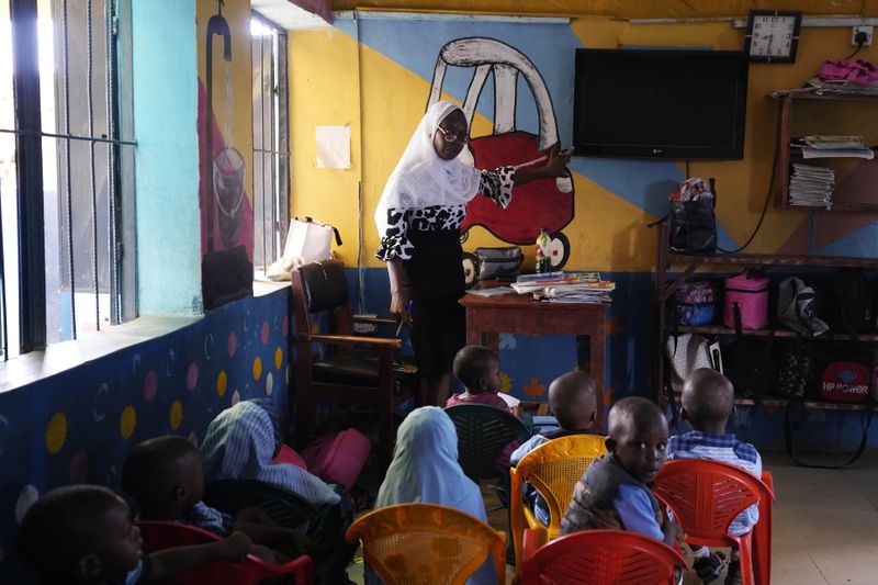 Students of Lorat Nursery and Primary School attend a lesson inside a classroom without electricity in Ibadan, Nigeria, Tuesday, May 28, 2024. The lack of reliable electricity severely affects education and businesses in Nigeria. (AP Photo/Sunday Alamba)