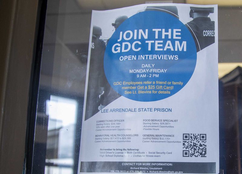 A Georgia Department of Corrections hiring flyer is displayed in the visitors lobby at Lee Arrendale State Prison in Alto on Wednesday, August 11, 2021. (Alyssa Pointer/The Atlanta Journal-Constitution)