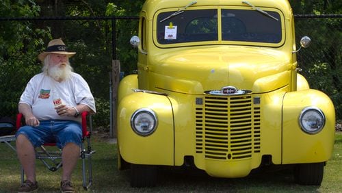 Mike Medley sits next to his 1948 international truck during the 28th annual Creepers Car Show at Jim R. Miller Park in Marietta on Saturday.