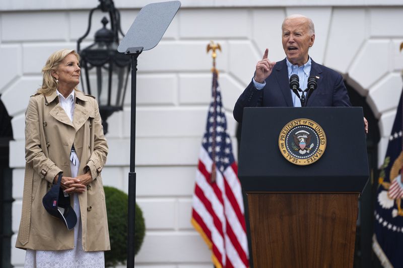 First lady Jill Biden listens as President Joe Biden speaks during a barbecue with active-duty military service members and their families on the South Lawn of the White House, Thursday, July 4, 2024, in Washington. (AP Photo/Evan Vucci)