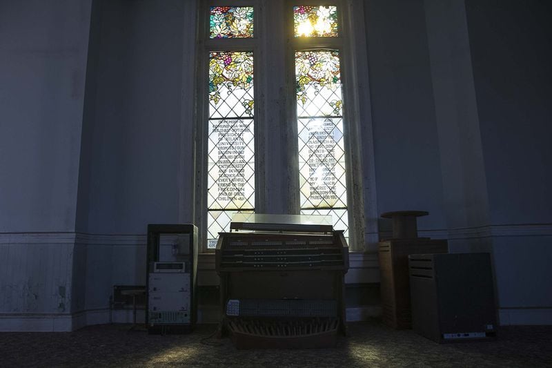 Sunlight peers through a stained glass window in the abandoned chapel space at Fountain Hall on the campus of Morris Brown College, Thursday, December 5, 2019. (ALYSSA POINTER/ALYSSA.POINTER@AJC.COM)