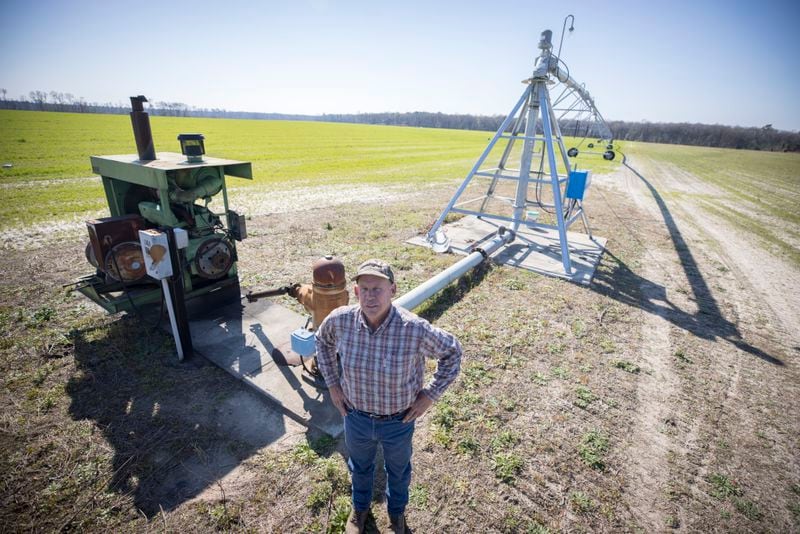 Ray Davis, a Bulloch County farmer, stands near one of his wells and pivots that irrigate part of his 1,100 acres. Davis is part of an activist group, the Bulloch Action Coalition, that has launched a petition drive meant to block the drilling of four new wells to serve Bryan County and the Hyundai electric vehicle factory. (AJC Photo/Stephen B. Morton)
