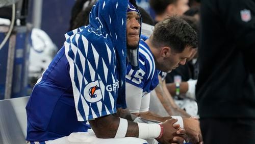 Indianapolis Colts quarterback Anthony Richardson, left, sits on the bench after being injured during the first half of an NFL football game against the Pittsburgh Steelers, Sunday, Sept. 29, 2024, in Indianapolis. (AP Photo/Darron Cummings)