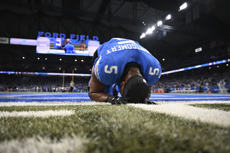 Detroit Lions running back David Montgomery (5) takes a moment after scoring a one-yard touchdown run against the Los Angeles Rams during overtime in an NFL football game in Detroit, Sunday, Sept. 8, 2024. (AP Photo/David Dermer)