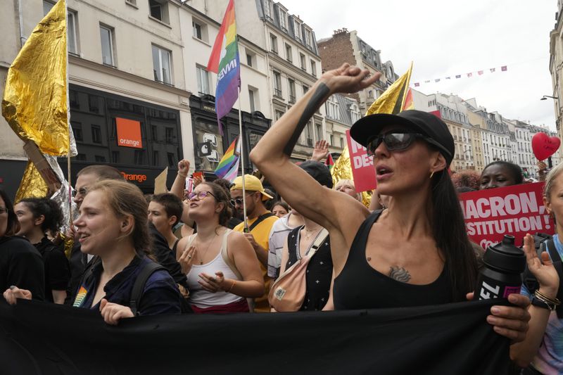 Demonstrators shout slogans during a protest, responding to a call from the far-left party who criticized as a power grab the president's appointment of a conservative new prime minister, Michel Barnier, in Paris, France, Saturday, Sept. 7, 2024. (AP Photo/Michel Euler)