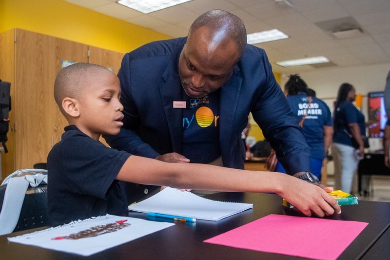 Superintendent Bryan Johnson (right) interacts with 11-year-old student Ronnie Burks at the Sylvan Hills Middle School’s first day of class in Atlanta on Thursday, Aug. 1, 2024.  (Ziyu Julian Zhu / AJC)