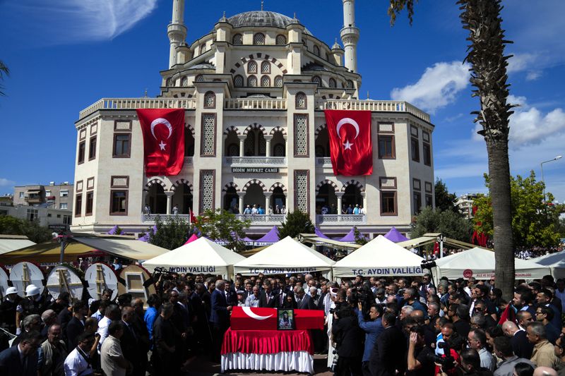 People attend the funeral prayers for Aysenur Ezgi Eygi, 26 year-old Turkish-American activist killed by the Israeli military, outside the central mosque of City of Didim, Turkey, Saturday, Sept. 14, 2024. (AP Photo/Khalil Hamra)