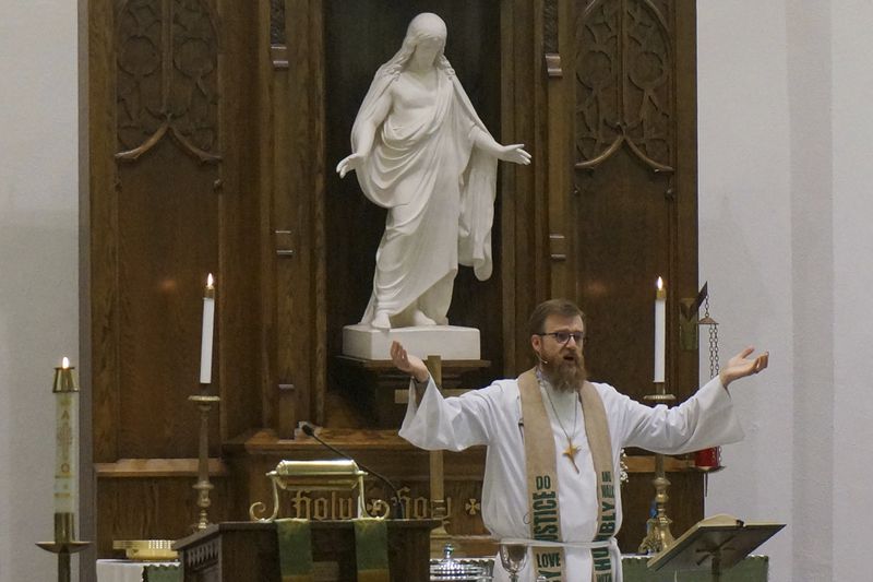 The Rev. Dustin Haider leads the Sunday service at Holden Lutheran Church near Kenyon, Minn, on Sept. 1, 2024. (AP Photo/Giovanna Dell'Orto)