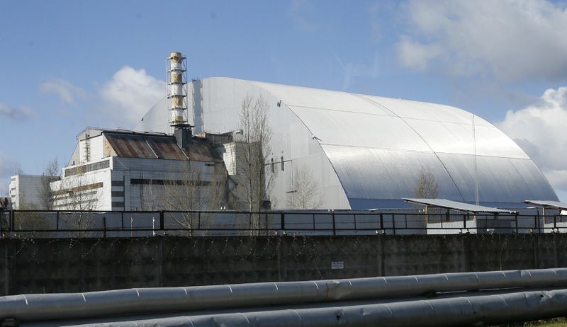 FILE - A shelter construction covers the exploded reactor at the Chernobyl nuclear plant, in Chernobyl, Ukraine, April 27, 2021. (AP Photo/Efrem Lukatsky, File)