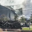 A large plume caused by a chemical reaction is still visible over the BioLab facility in Conyers, where a fire broke out Sunday.