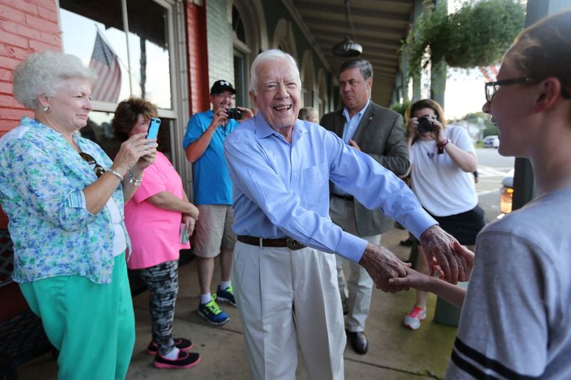 President Jimmy Carter shakes hands as he arrives at a birthday party for his wife Rosalynn in 2015 in Plains. (Ben Gray / bgray@ajc.com)