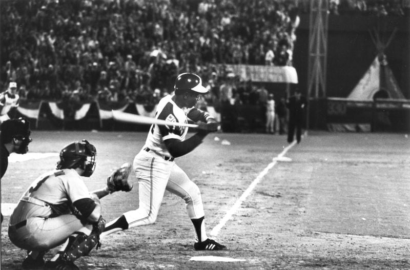 Third base sits in the background as Henry Aaron begins the swing that broke Babe Ruth's career home run record. Billy Downs / AJC