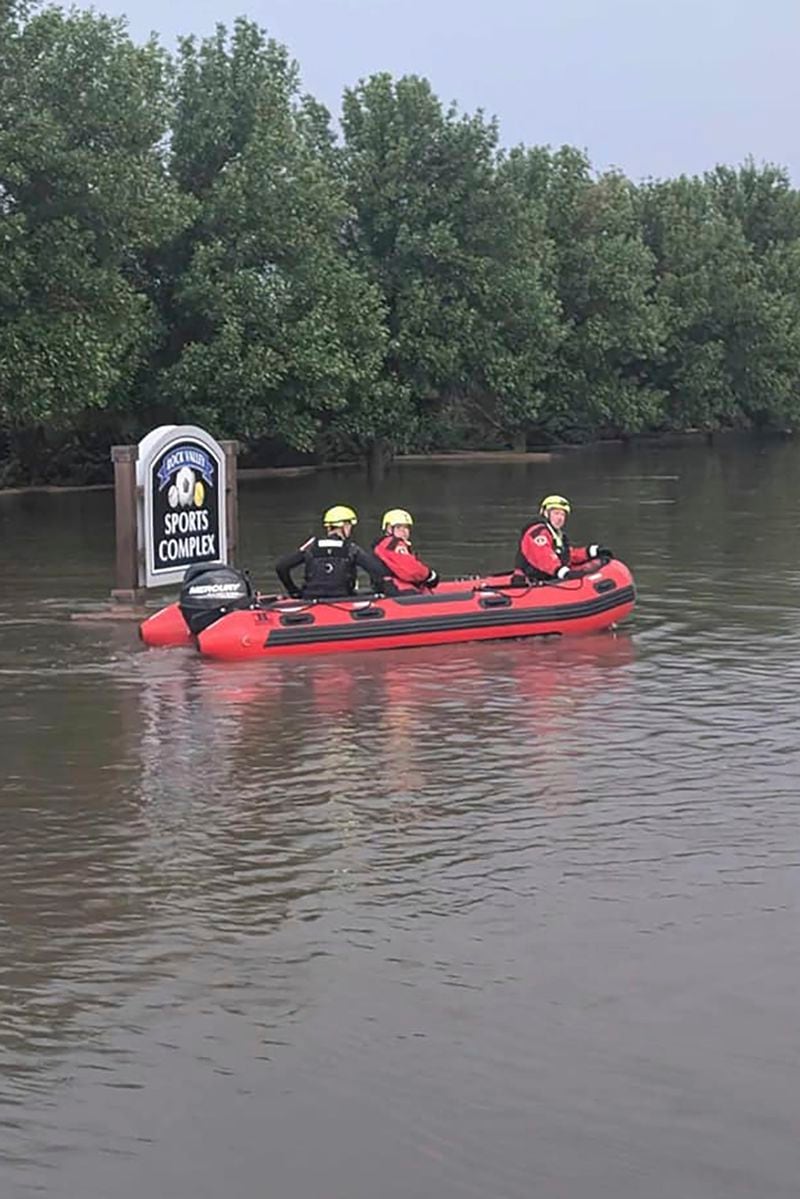 This photo provided by Sioux City Fire Rescue shows Sioux City Fire Rescue's Urban Search and Rescue team assists in evacuating Rock Valley, Iowa due to a breached levy on Saturday, June 22, 2024. (Kevin Maloney/Sioux City Fire Rescue via AP)