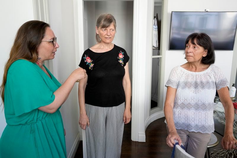 Lawyer Laura Sgro', left, talks to Mirjam Kovac, center, and Gloria Branciani, as they arrive for an interview with the Associated Press, in Rome, Friday, June 28, 2024. Kovac and Branciani are two of five women who urged Catholic bishops around the world to remove from their churches mosaics by ex-Jesuit artist Rev. Marko Rupnik after they accused him of psychologically, spiritually and sexually abusing them. (AP Photo/Andrew Medichini)