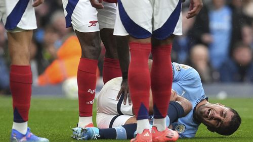 Manchester City's Rodri reacts to an injury, during the English Premier League soccer match between Manchester City and Arsenal at the Etihad stadium in Manchester, England, Sunday, Sept. 22, 2024. (Martin Rickett/PA via AP)