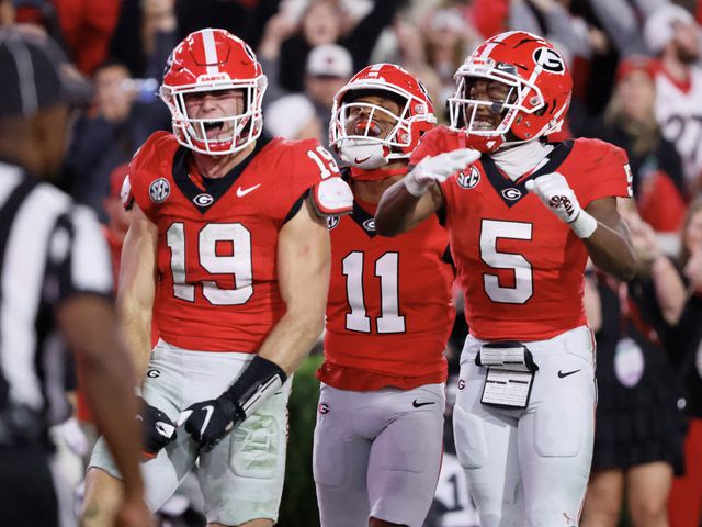 Georgia Bulldogs tight end Brock Bowers (19) celebrates his second half touchdown with wide receiver Arian Smith (11) and  wide receiver Rara Thomas (5) during the second half.  (Bob Andres for the Atlanta Journal Constitution)
