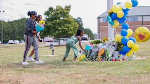  9-year-old Gianna White, along with 14-year-olds Alannah Parrish and Amy Lumpkin from Clark County, arrived at Apalachee High School to pay their respects. This was a day after a tragic event at a Barrow County high school, where a 14-year-old opened fire on Wednesday morning, resulting in the loss of two students and two teachers, as well as injuries to nine others. Thursday, Sep 5, 2024. (Miguel Martinez/AJC)