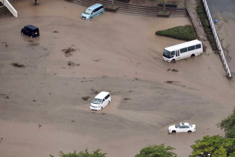 In this aerial photo, the car park of a municipal office is seen under water, after heavy rain in Wajima, Ishikawa prefecture, Saturday, Sept. 21, 2024. (Kyodo News via AP)