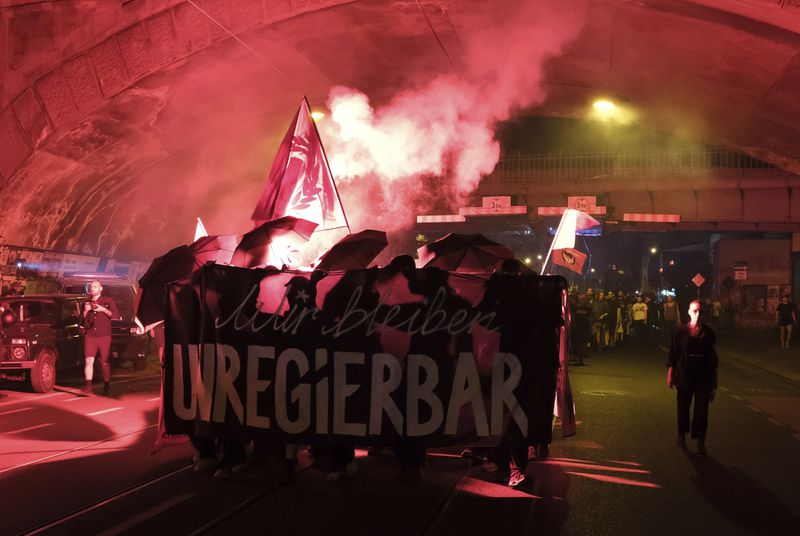 Protesters light pyrotechnics during a rally against the growth of right-wing parties in the state elections for Saxony, in Dresden, Germany, Sunday, Sept. 1, 2024. (Sebastian Willnow/dpa via AP)