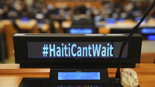 The social media slogan #HaitiCantWait is displayed as Canada Prime Minister Justin Trudeau takes part in high level meeting with an advisory group on Haiti at the United Nations headquarters on Monday, Sept. 23, 2024. (Sean Kilpatrick/The Canadian Press via AP)