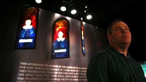 Gwinnett County Commissioner Tommy Hunter, seen here with a memorial to the four girls killed in a 1963 church bombing in Birmingham, Alabama, and his colleagues on the Board of Commissioners visited the National Center for Civil and Human Rights on Tuesday. Hunter recently called civil rights leader John Lewis a “racist pig.” HENRY TAYLOR / HENRY.TAYLOR@AJC.COM