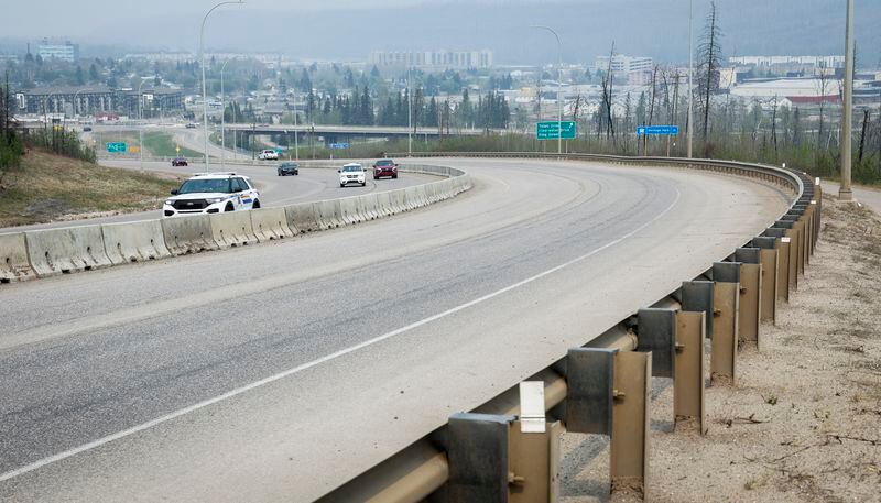 Traffic moves along Alberta Highway 63 as wildfire smoke hangs in air in Fort McMurray, Alta., on Wednesday, May 15, 2024. (Jeff McIntosh /The Canadian Press via AP)