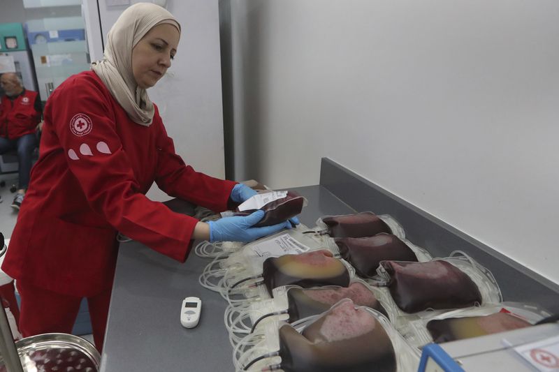 A Lebanese Red Cross volunteer collects blood donations for those who were injured by their exploded handheld pagers, Tuesday, Sept. 17, 2024, at a Red Cross center in the southern port city of Sidon, Lebanon,. (AP Photo/Mohammed Zaatari)