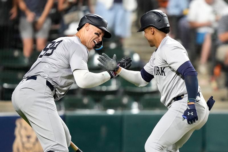 New York Yankees' Juan Soto, right, celebrates his home run off Chicago White Sox starting pitcher Jonathan Cannon with Aaron Judge during the fifth inning of a baseball game Tuesday, Aug. 13, 2024, in Chicago. (AP Photo/Charles Rex Arbogast)