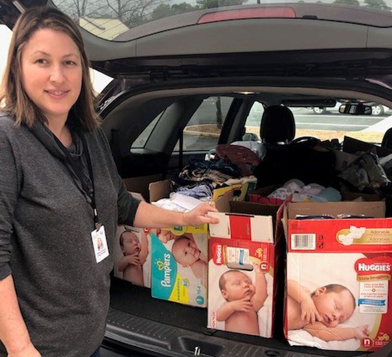 Sherri Feliccia, a Project GRANDD case manager with donated baby supplies.