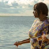 Chef Sallie Ann Robinson expertly throws her crab net into the water, blending skill with heritage as she gathers fresh crabs for her signature dish, Ol' 'Fuskie Fried Crab Rice. (Adriana Iris Boatwright for the Atlanta Journal-Constitution)