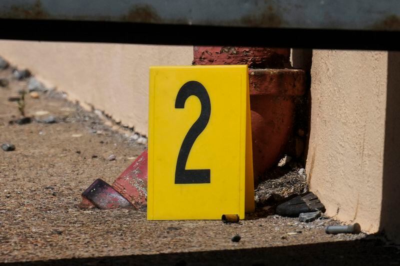 An evidence marker is place next to a cartridge case at the scene the scene of a fatal shooting at Delaware County Linen in Chester, Pa., Wednesday, May 22, 2024. Authorities say a former employee armed with a handgun opened fire at a linen company in a Philadelphia suburb, killing multiple people and wounding three others. (AP Photo/Matt Rourke)