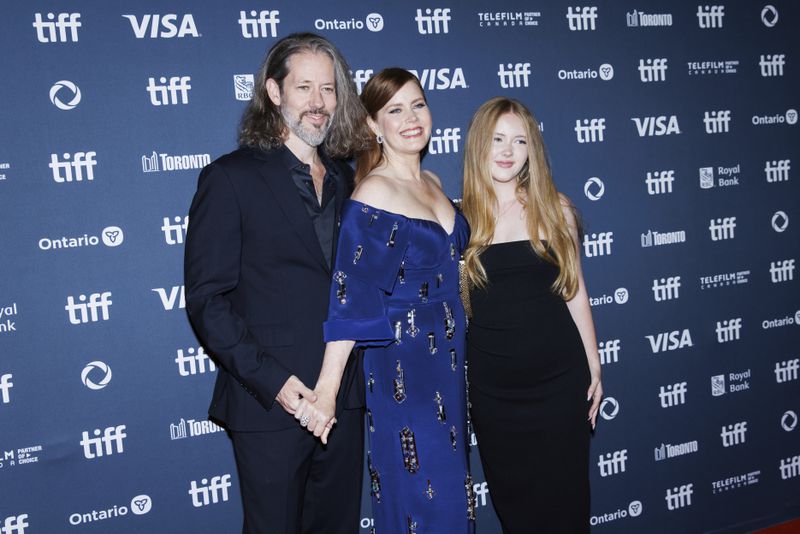 Darren Le Gallo, Amy Adams and Aviana Le Gallo, arrive on the red carpet for the premiere of 'Nightbitch' at Princess of Wales Theatre, during the Toronto International Film Festival in Toronto, Saturday, Sept. 7, 2024. (Cole Burston/The Canadian Press via AP)