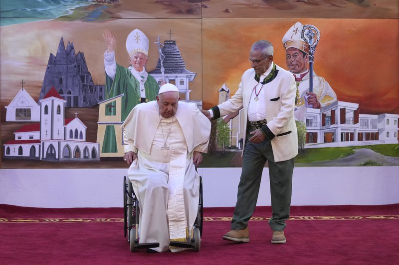 Pope Francis is helped by East Timor President Jose Ramos-Horta to get up from his wheelchair during the welcome ceremony at the Presidential Palace in Dili, East Timor, Monday, Sept. 9, 2024. (AP Photo/Dita Alangkara, Pool)