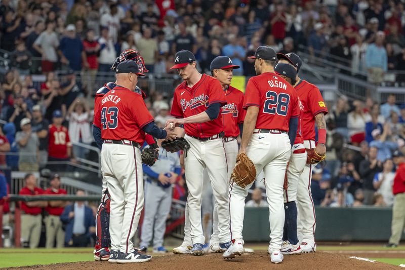 Atlanta Braves pitcher Max Fried, center, hands the ball to manager Brian Snitker (43) after being relieved in the ninth inning of a baseball game against the Kansas City Royals, Friday, Sept. 27, 2024, in Atlanta. (AP Photo/Jason Allen)