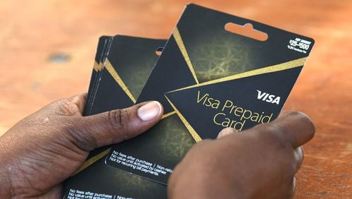 DeKalb County gave out $100 prepaid debit cards to people who got the COVID-19 vaccine shot during an event at The Gallery at South DeKalb on Saturday, Aug. 14. (Hyosub Shin / Hyosub.Shin@ajc.com)