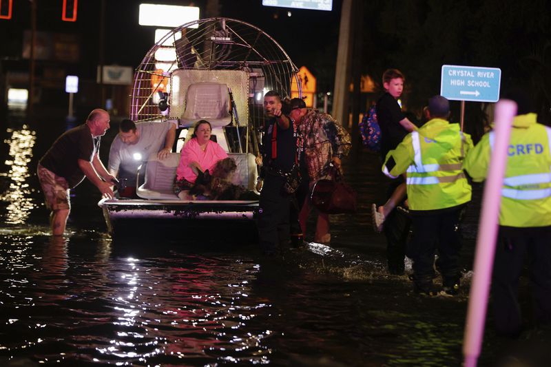 People and pets are rescued from flooded neighborhoods in the aftermath of Hurricane Helene on Friday, Sept. 27, 2024 in Crystal River, Fla. (Luis Santana/Tampa Bay Times via AP)