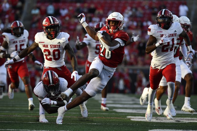 Louisville running back Duke Watson (26) runs from the Jacksonville State defense during the second half of an NCAA college football game in Louisville, Ky., Saturday, Sept. 7, 2024. (AP Photo/Timothy D. Easley)