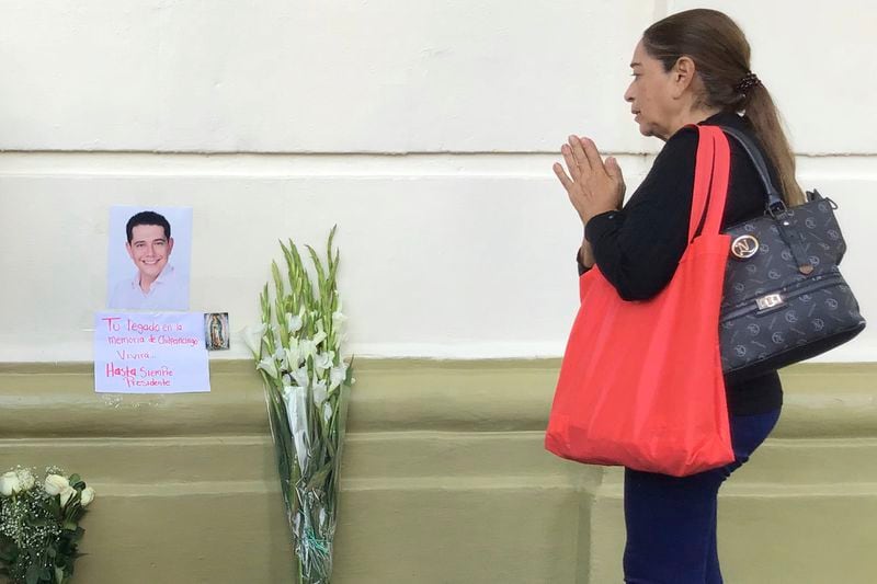 A supporter of slain Mayor Alejandro Arcos prays at the entrance of the municipal building one week after he took office in Chilpancingo, Mexico, Monday, Oct. 7, 2024. (AP Photo/Alejandrino Gonzalez)