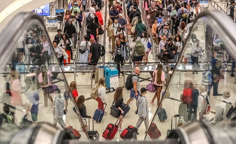 Crowds streamed into Hartsfield-Jackson International Airport on Friday, June 28, 2024, which is expected to be a peak day in the Fourth of July travel period. Credit: John Spink / jspink@ajc.com
