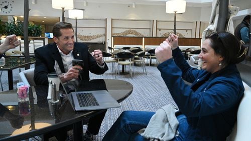 U.S. Rep. Rich McCormick reacts with Brittany McGivern (right) after he successfully made a call to encourage to vote for presidential candidate Florida Gov. Ron DeSantis at a hotel lobby, Sunday, January 14, 2024, in West Des Moines, Iowa. (Hyosub Shin / Hyosub.Shin@ajc.com)