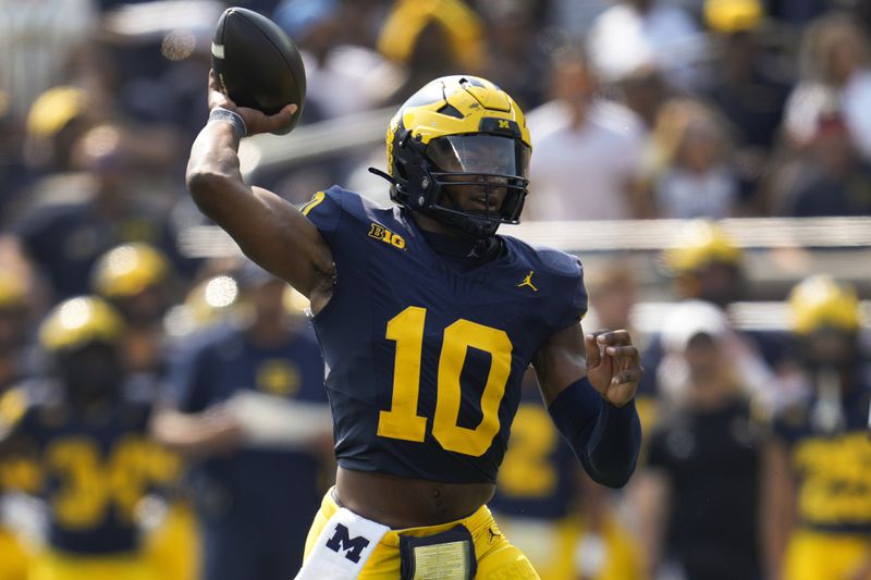 Michigan quarterback Alex Orji (10) throws against Arkansas State in the second half of an NCAA college football game in Ann Arbor, Mich., Saturday, Sept. 14, 2024. (AP Photo/Paul Sancya)