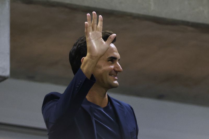 Tennis great Roger Federer waves to the crowd during the quarterfinal match between Aryna Sabalenka, of Belarus, and Zheng Qinwen, of China, during the U.S. Open tennis championships, Tuesday, Sept. 3, 2024, in New York. (AP Photo/Adam Hunger)