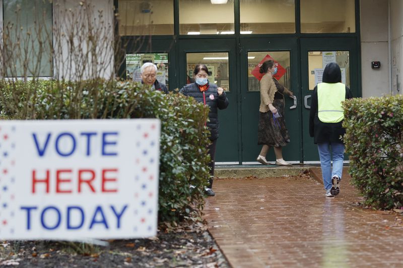 People come in and out at Ashford Park Elementary School during election day on Tuesday, December 6, 2022.
 Miguel Martinez / miguel.martinezjimenez@ajc.com